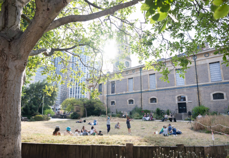 People sitting on grass outside St John's Waterloo church