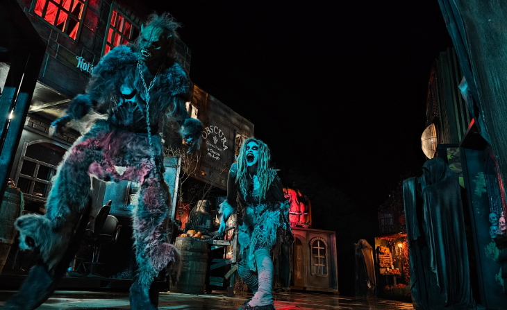 Halloween 2026 parties in London: a monster character in chains in the middle of a fake street scene at The Nightmare Realm