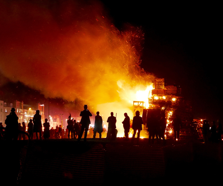 Biggest bonfires in south-east England 2026: figures silhouetted in the dark against Hastings bonfire