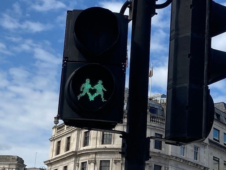 Pedestrian crossing lights showing two people holding hands