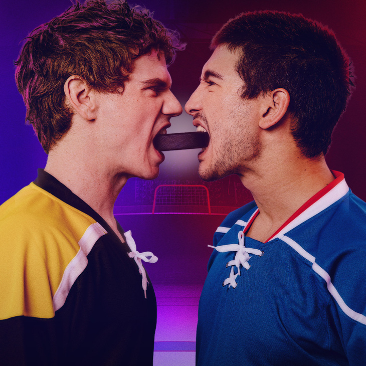Two men with a puck between their teeth