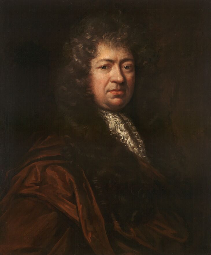 A portrait of a middle-aged man with a large, dark curly wig, wearing a white lace cravat and a dark brown cloak, set against a dark background.