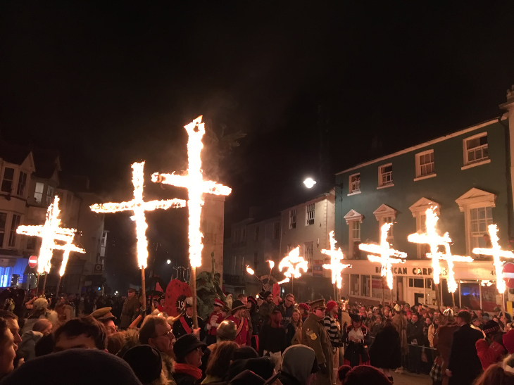 Biggest bonfire events in south-east England 2026: Crowds of people carrying blazing crosses down Lewes High Street.