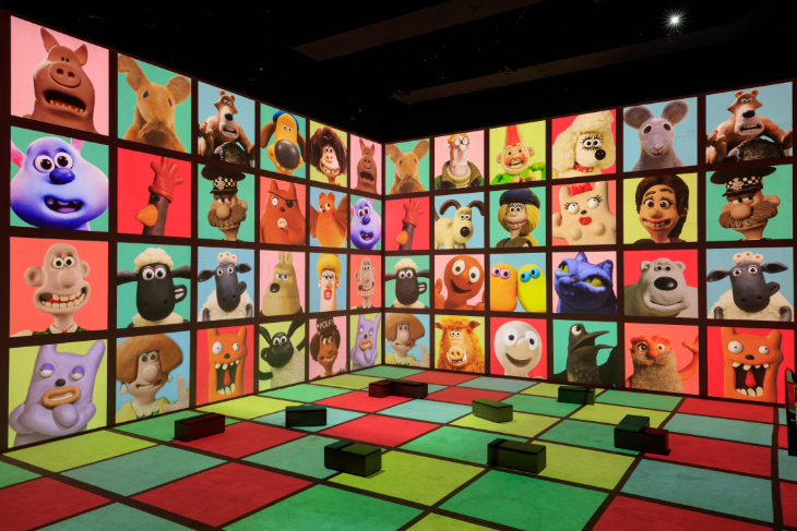 Things to do in London in October 2026: an illuminated wall covered in colourful squares, each one depicting an Aardman character