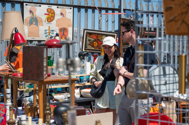Things to do in London this weekend: two people browsing at an open-air flea market