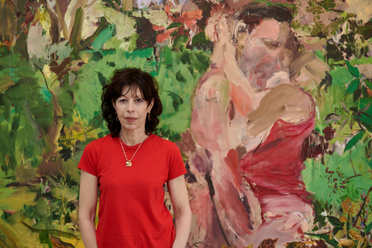 Things to do in London today: artist Cecily Brown in front of a large painting of a couple embracing