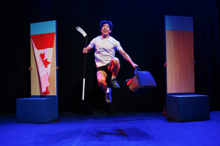Things to do in London in October 2026: an actor on stage with a hockey stick in one hand and a gym bag in the other, with a Canadian flag in the background