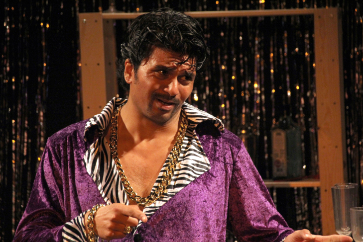 Things to do in London today: a man dressed in a purple velvet shirt with zebra print colour, with oversized jewellery around his neck and wrist
