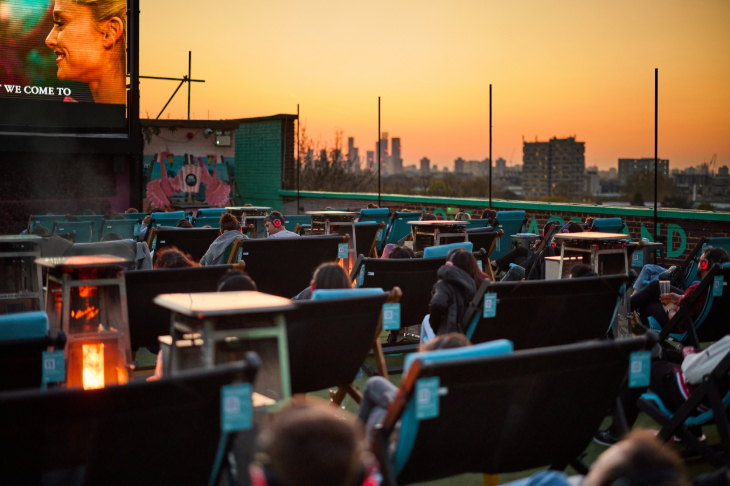 Halloween 2026 film screenings London: people in deckchairs at an open-air cinema at sunset