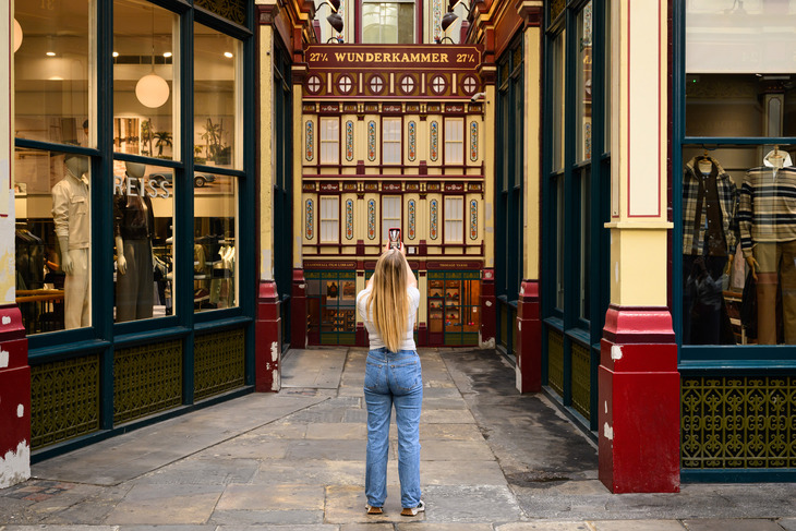A person taking a photo of the display