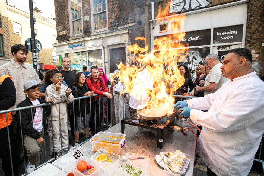 Someone cooking a curry on a very high flame