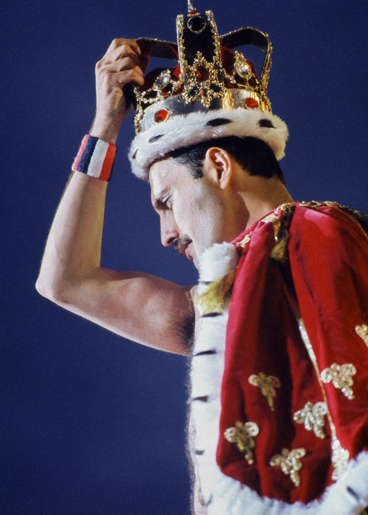 Freddie Mercury wearing a regal red robe and gold crown