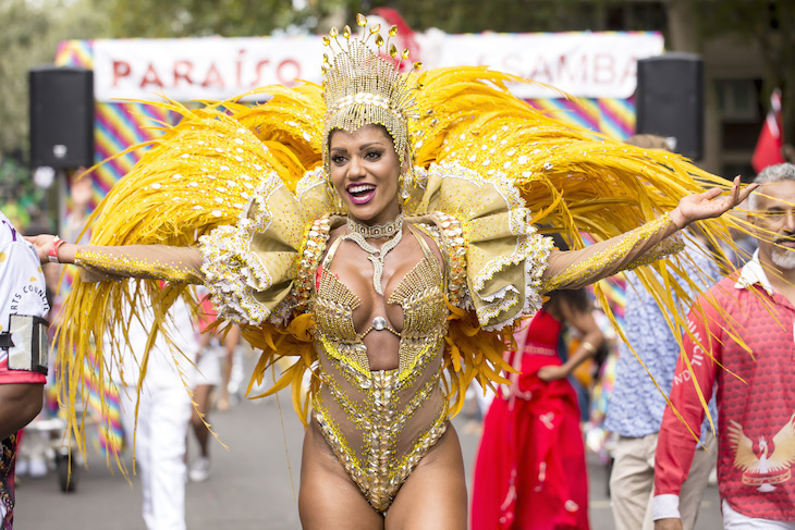 a woman in a dazzling gold carnival costume