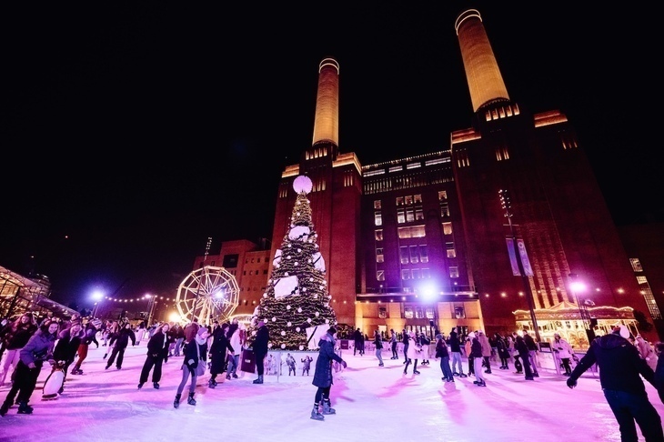 Christmas 2026 ice rinks in London: people skating around a Christmas tree in front of Battersea Power Station