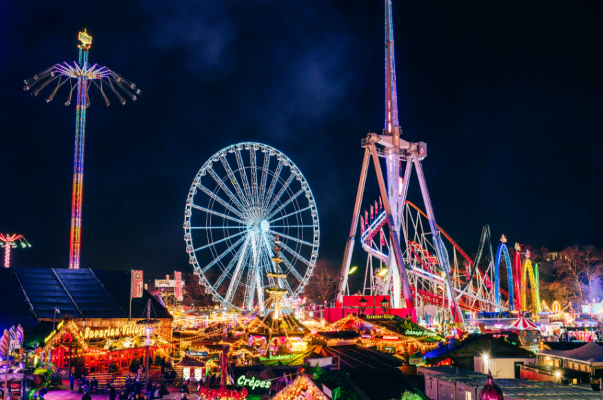 Hyde Park Winter Wonderland Christmas 2026 guide: rollercoasters and other funfair rides illuminated against the night sky
