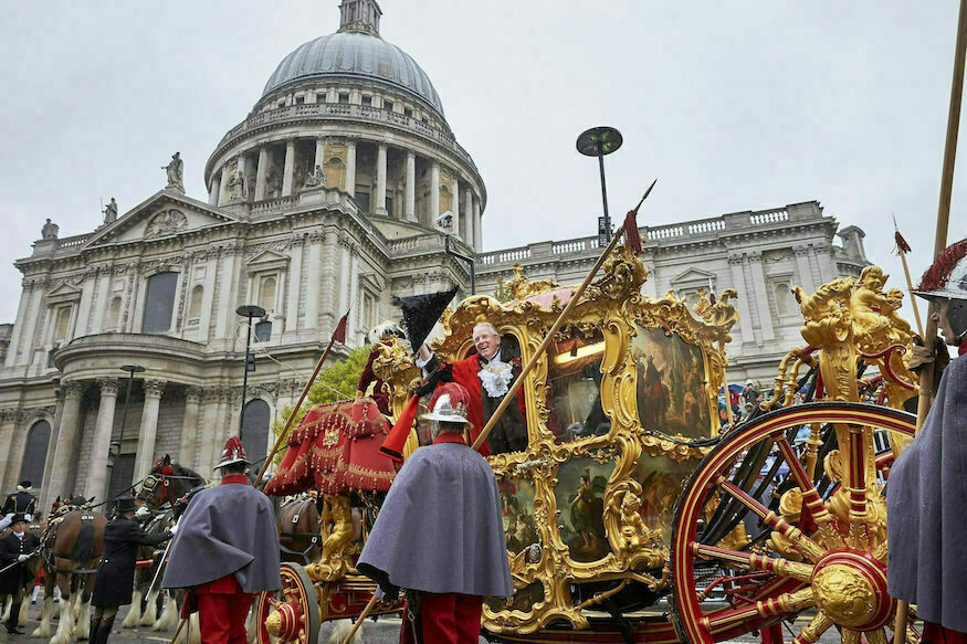 Lord Mayor's Show 2026: a Lord Mayor in ceremonial robes leans out of the gold state coach outside St Paul's to wave at crowds.