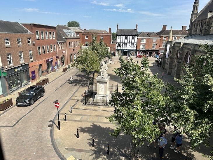 A statue of Samuel Johnson seen from a first floor window.