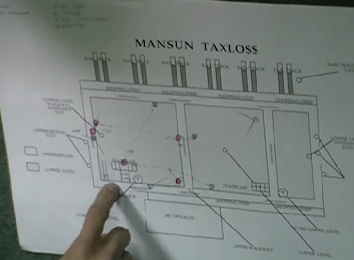 A finger points at a plan of Liverpool Street station