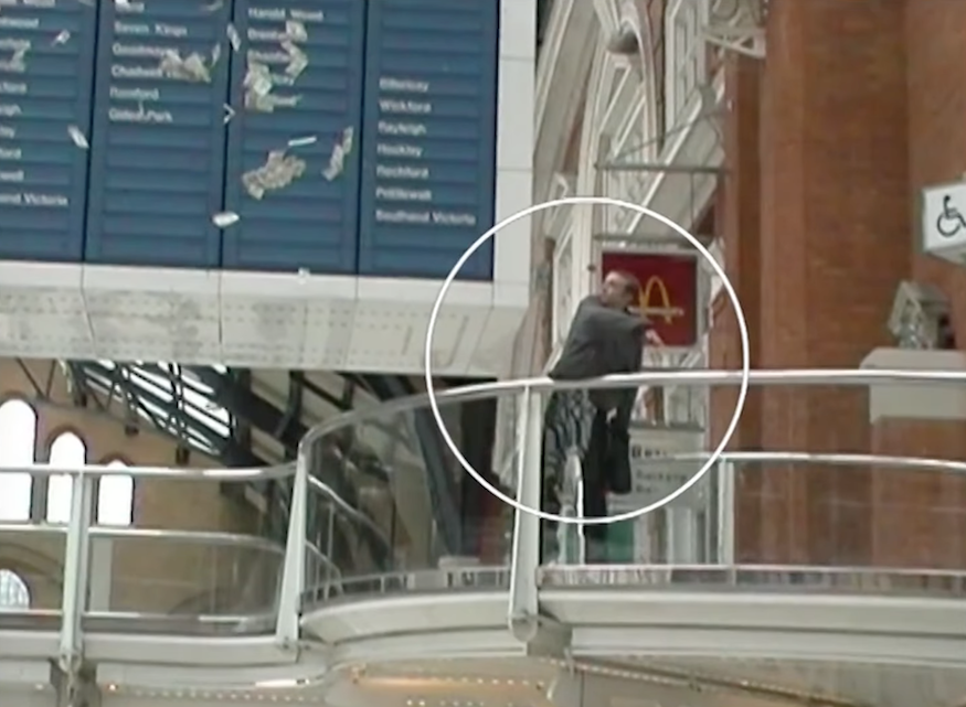 A man throws 5 pound notes in liverpool street station