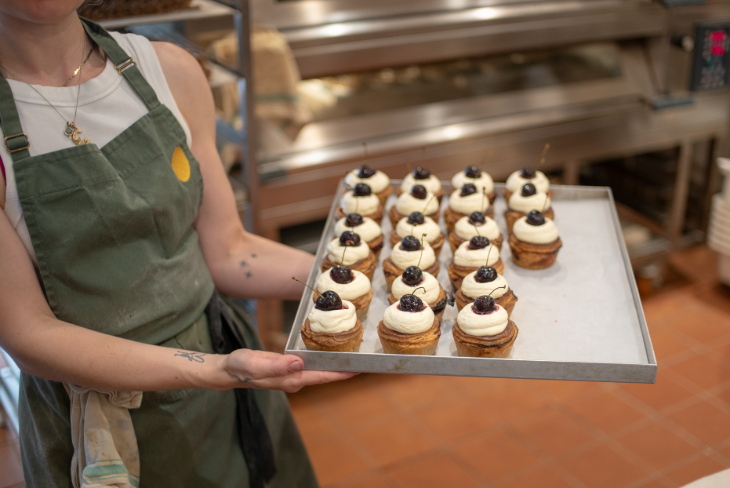 Things to do in London August bank holiday weekend 2026: a person holding a silver tray of pies topped with cherries