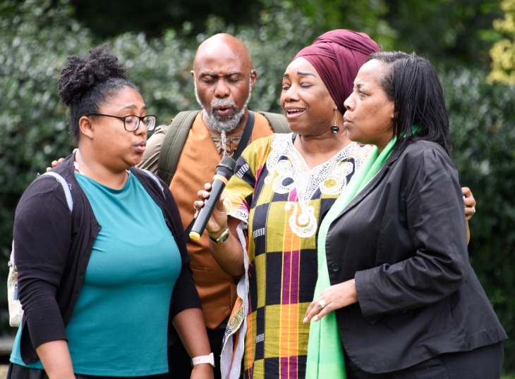 What's on in London today: a group of four people gathered around a microphone singing