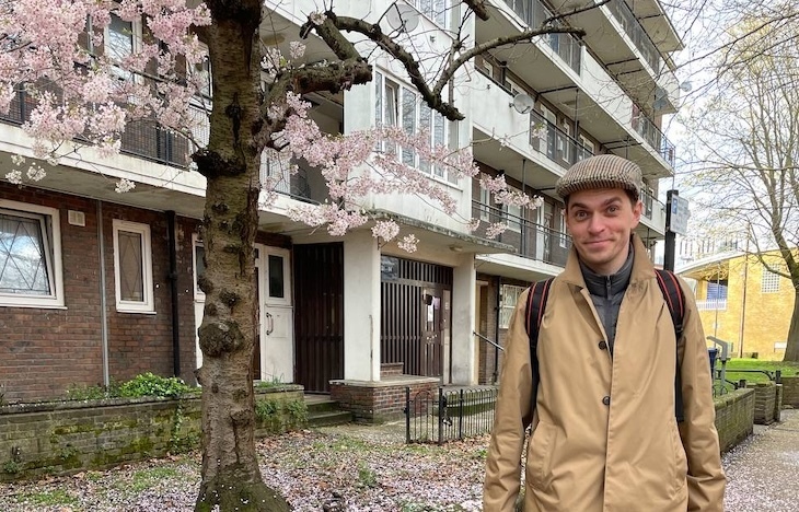 Elia Kabanov in front of a cherry blossom