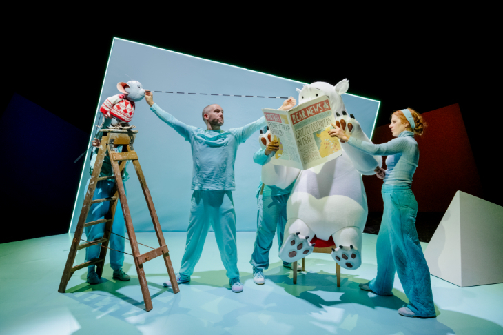 Family Christmas theatre shows 2026: four people on stage operation puppets of a large polar bear sitting on a chair reading a newspaper, and a mouse at the top of a ladder looking towards the bear