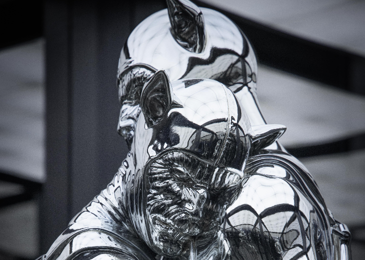 The head and shoulders of two mirrored figures in an embrace
