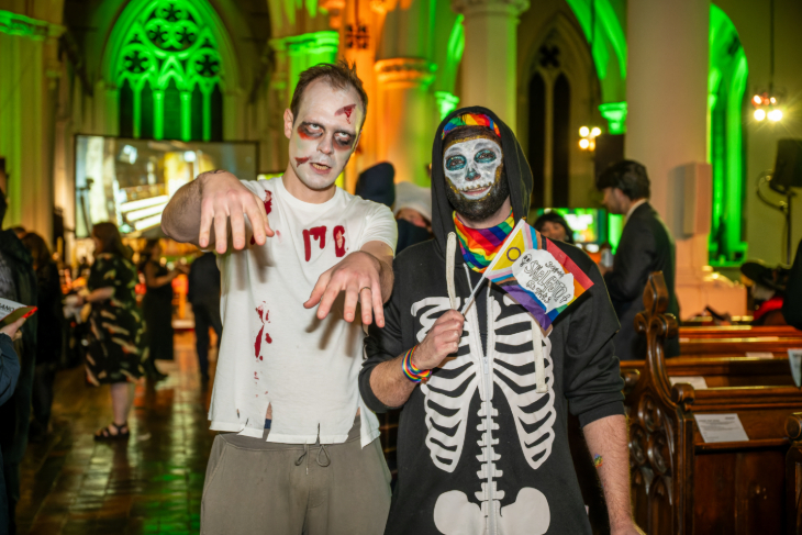 Halloween 2026 in London: a person dressed as a zombie and another dressed as a skeleton inside a church building which is illuminated in green