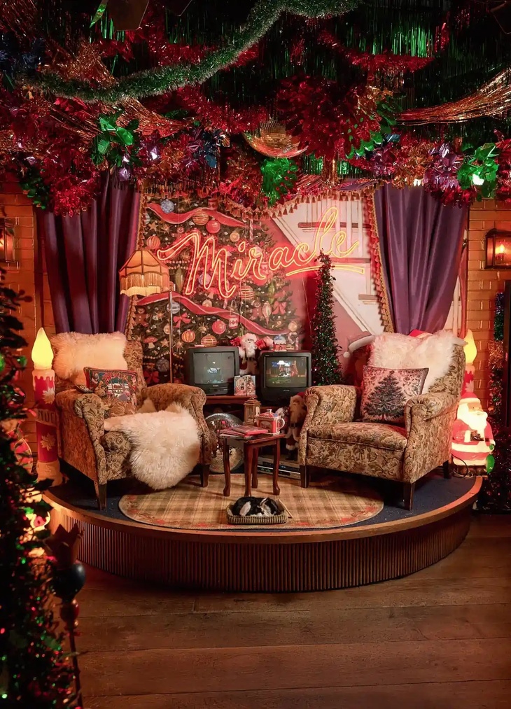 An old school Christmas setup with armchairs and TVs