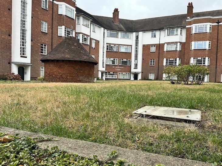 A 1930s housing estate with a circular shelter entrance on the lawn