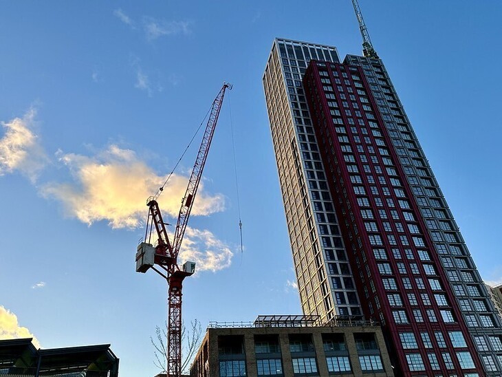 A crane in front of a newbuilt