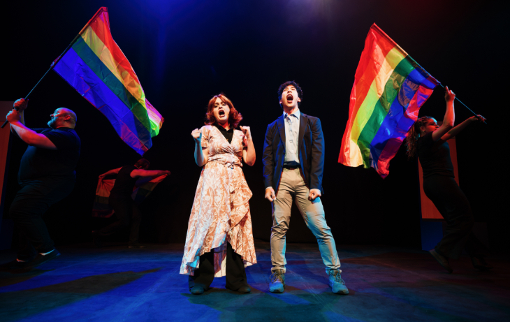 Things to do in London today: two people singing on stage, in front of LGBTQ rainbow flags