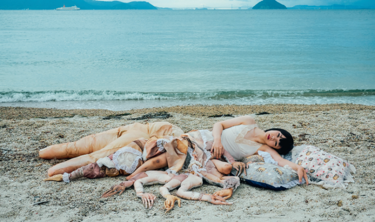 Things to do in London this weekend: a photograph of a woman who appears to have several limbs laying on a beach