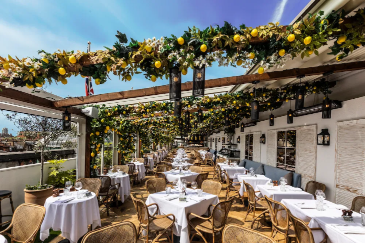 Things to do in London this weekend: a rooftop restaurant decked out for summer, with boughs of lemon trees strung over a pergola