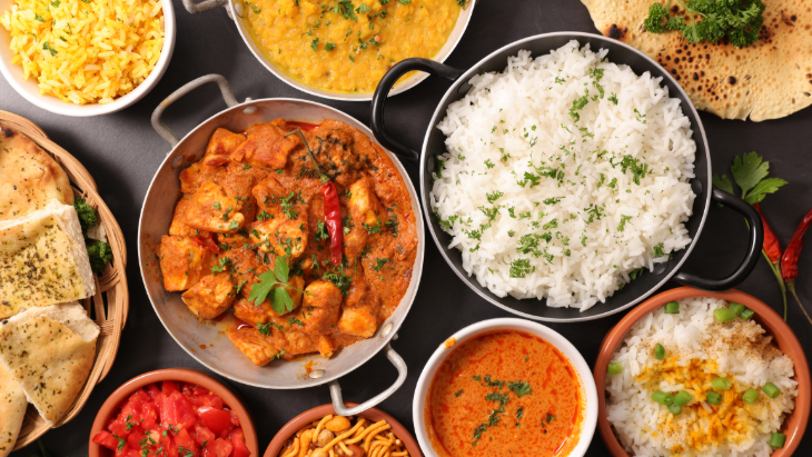 Things to do in London today: various curry and rice dishes on a table