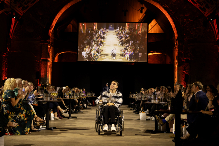 A fashion show catwalk, with the model in a wheelchair