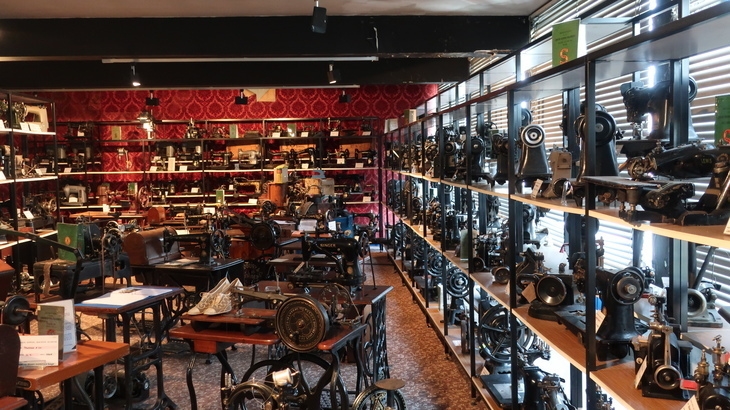 Things to do in London today: a room with tables covered in sewing machines, and more machines on shelves lining the edge of the room