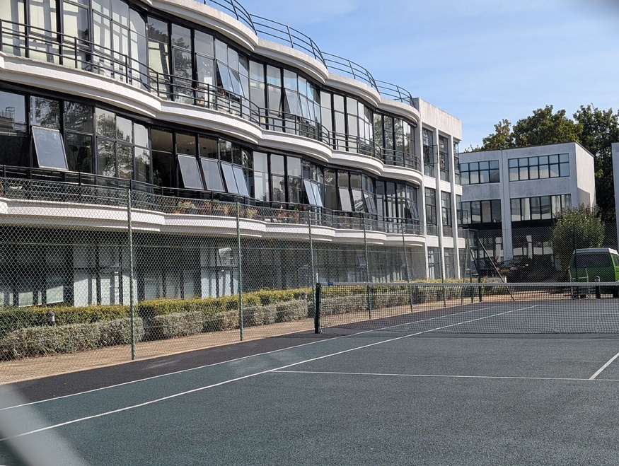 The front of the centre, with a tennis court in front of that