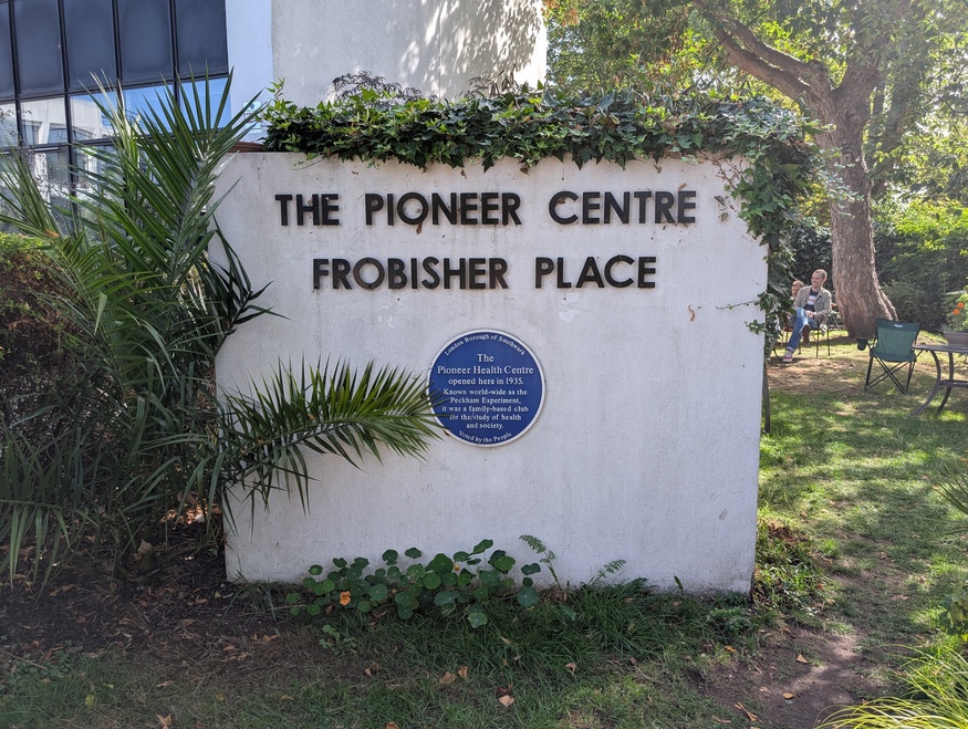 A blue plaque marking the site of the Pionner Centre