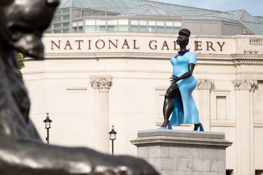 The National Gallery in the background behind a statue of a woman wearing a blue dress
