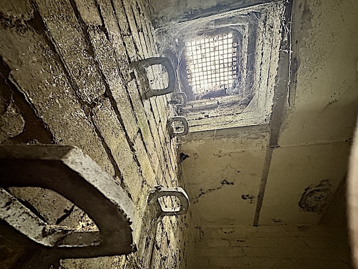 Iron rungs leading up to an escape hatch in a second world war bunker.