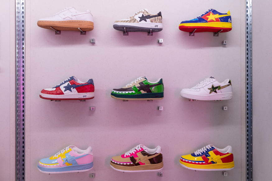 Things to do in London today: nine colourful trainers, displayed individually in a museum displasy case
