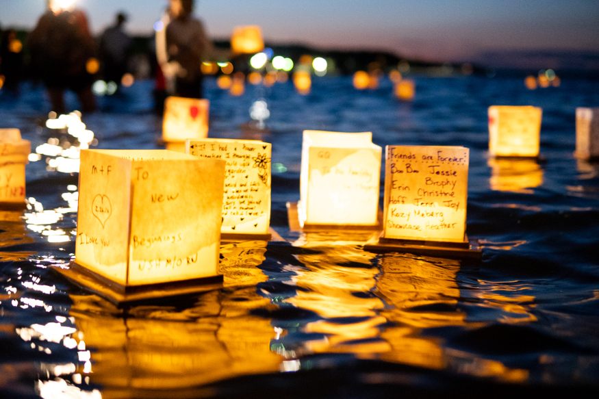 Things to do in London this weekend: glowing cube shaped lanterns floating on a lake at dusk