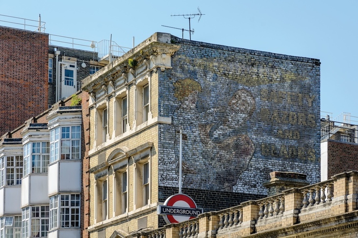The ghost sign with a roundel in front of it