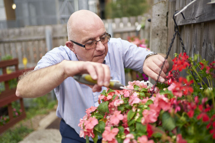 A man pruning flowers