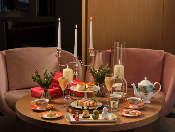 Best Christmas afternoon tea in London 2026: a festive afternoon tea served on a round wooden table