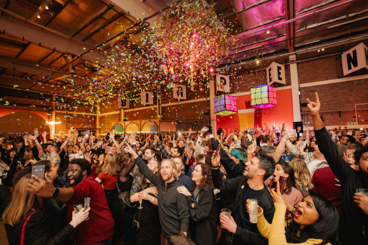 New Year's Eve parties London: People dancing in a large hall with confetti falling from the ceiling