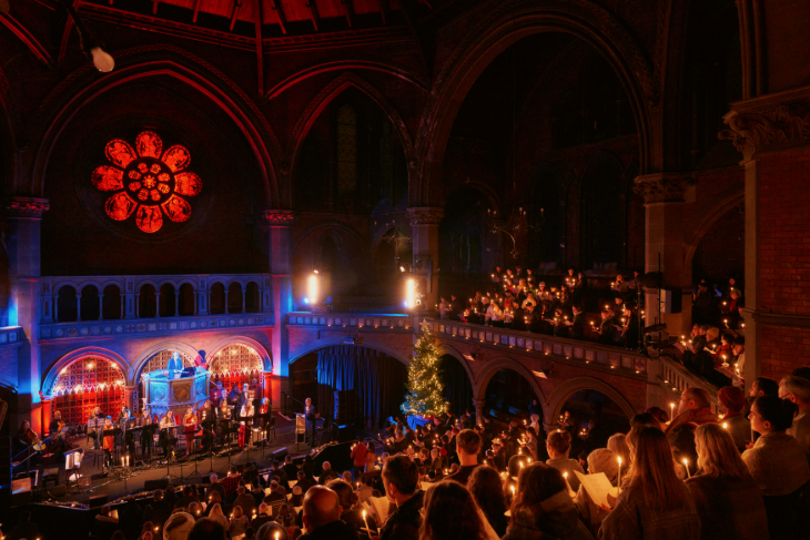 Christmas carol concerts London 2026: people holding candles in pews and balconies at Union Chapel