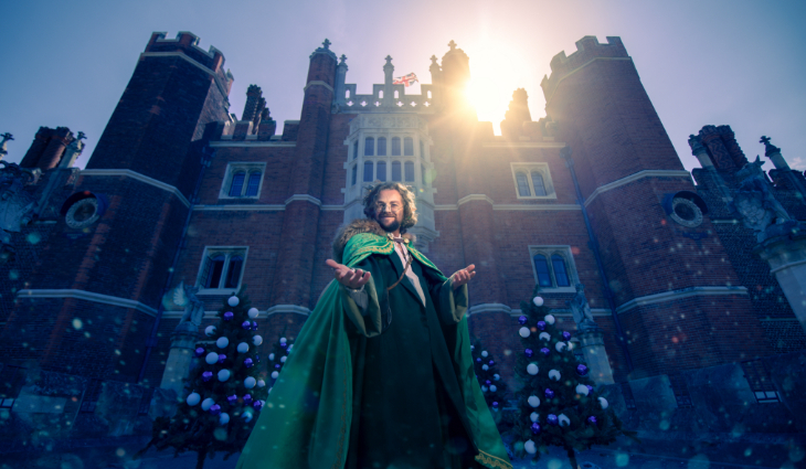 Things to do with kids in London at Christmas 2026: a character in a cape outside a festively decorated Hampton Court Palace